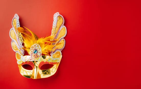 Happy Purim carnival. Carnival mask for Mardi Gras celebration isolated on red background banner design with copy space, jewish holiday, Purim in Hebrew holiday carnival ball, Venetian mask