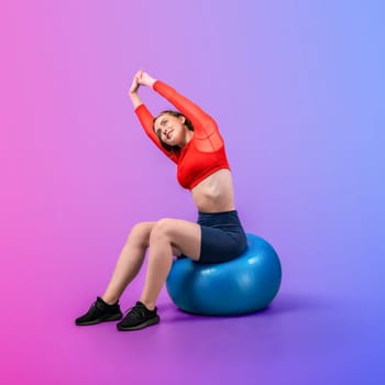 Full body length gaiety shot athletic and sporty young woman with fitness exercising ball in standing posture on isolated background. Healthy active and body care lifestyle.