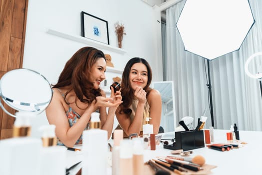 Woman influencer shoot live streaming vlog video review makeup uttermost social media or blog. Happy young girl with cosmetics studio lighting for marketing recording session broadcasting online.