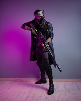 tough guy killer in a demon mask and black raincoat with a sniper airsoft rifle in his hands