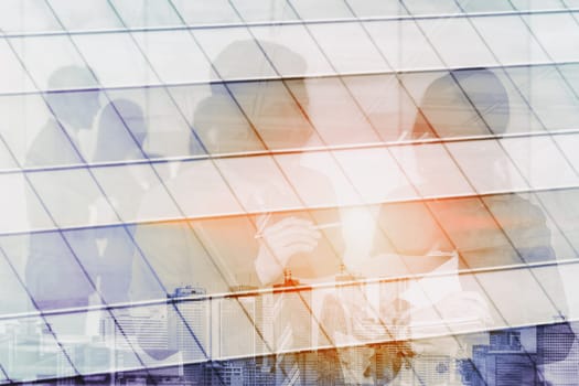 Double exposure image of faded business abstract background with office building and people conference group meeting showing partnership success of business deal. uds