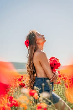 Woman poppies field. portrait of a happy woman with long hair in a poppy field and enjoying the beauty of nature in a warm summer day