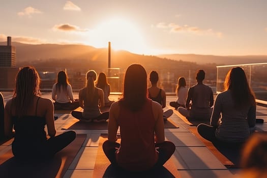 Group yoga class on the roof of a building in the sun.