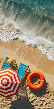 Aerial shot of a sunny beach scene with colorful umbrella, lounge chairs, and a lifebuoy on the sand.