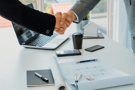 Businessman executive handshake with businesswoman worker in modern workplace office. People corporate business deals concept. uds