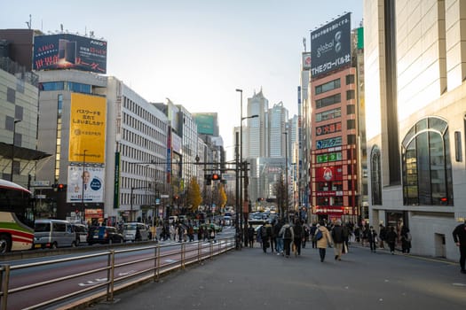 Tokyo, Japan. January 9, 2024. crowd of people on a sidewalk waiting to cross the street in the city center