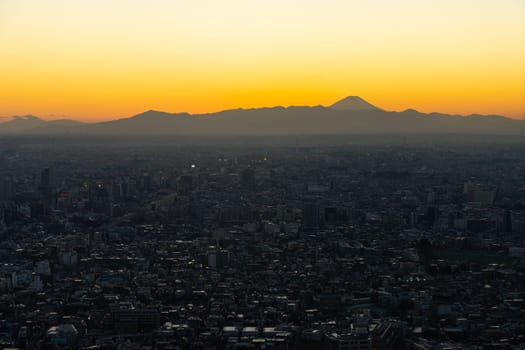 Tokyo, Japan. January 9, 2024. Mount Fuji seen at sunset from the city center