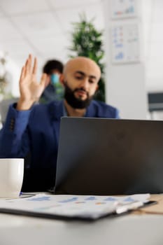 Project manager attending videocall to discuss strategy and plans in business office. Strat up entrepreneur using laptop for corporate online meeting call with colleagues