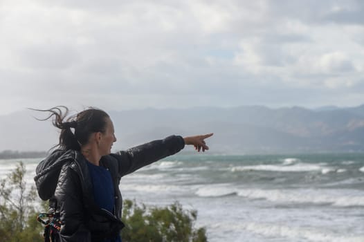 portrait of a woman pointing to the Mediterranean Sea in Cyprus 2