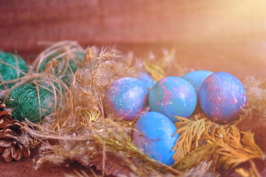 space galactic Easter eggs in nest next to cone and green filler