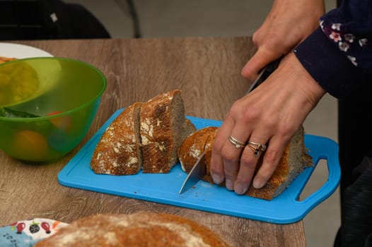 woman cutting freshly baked homemade bread in the kitchen 5