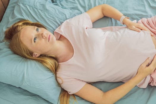 Sleep-deprived pregnant woman struggles with insomnia, navigating the challenges of restlessness during pregnancy.