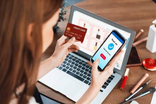 Woman shopping online on internet marketplace browsing for sale items for modern lifestyle and use credit card for online payment from wallet protected by utmost cyber security software