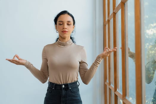 Young African American woman practice crucial mindful meditation at home living room for improving mental health strength and peaceful beautiful living