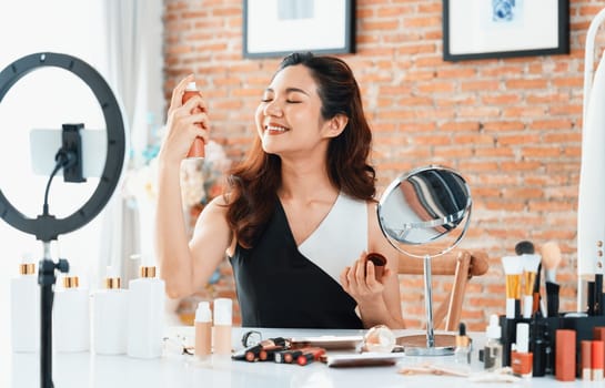 Woman influencer shoot live streaming vlog video review makeup uttermost social media or blog. Happy young girl with cosmetics studio lighting for marketing recording session broadcasting online.