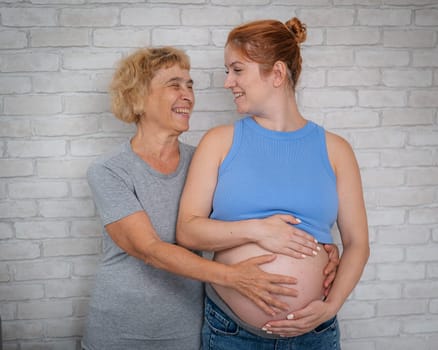 Elderly woman and her adult pregnant daughter