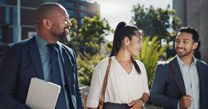 Business people, walking and travel in city with talking on morning commute, partnership and happy. Employees, men and woman with conversation, collaboration and networking outdoor in urban town.