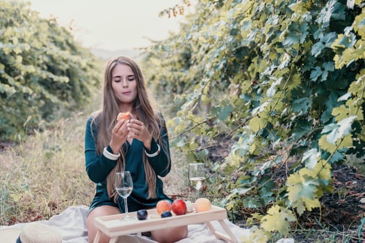 Picnic and wine tasting at sunset in the hills of Italy, Tuscany. Vineyards and open nature in the summer. Romantic dinner, fruit and wine.