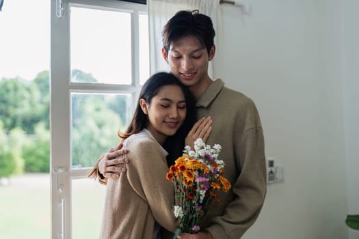 Young couple Hug and giving flower on Valentine's Day. Romantic day together. Valentine's Day concept.