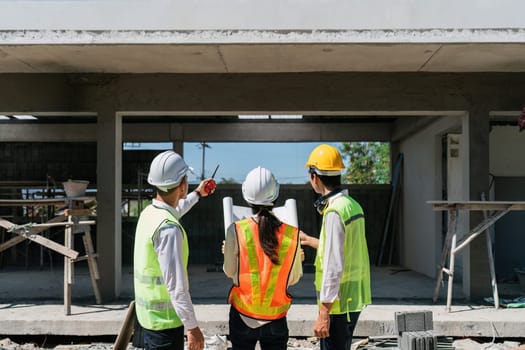 team engineer, foreman, architect meeting for colleagues discussing and checks construction blueprints at onsite.