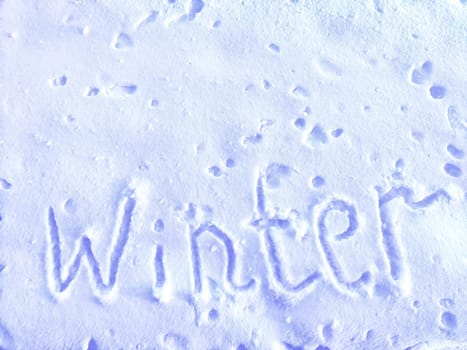 Inscription Hi Winter, written on white background of the snow. Top view. Flat lay. New year, Christmas