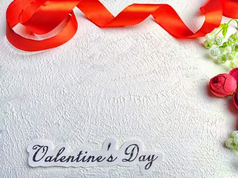 White background, flowers, red ribbon and Valentine's Day inscription. Concept of holiday. Card, Background, Texture, Frame, copy space, place for text