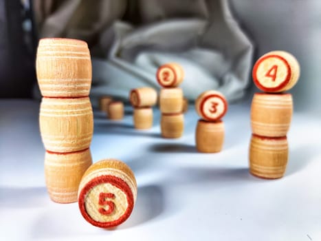 Small wooden barrels with numbers built in columns. The concept of duration and ways to achieve the goal. The sequence of actions to obtain the effect and result