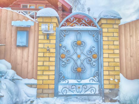 New gate, entrance to a private territory on a winter day and snow. Metallic texture and background. Fence