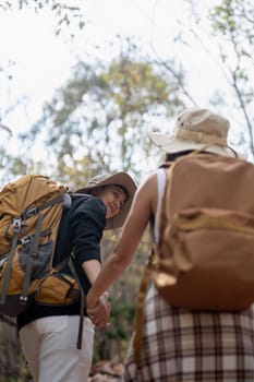 Lovely couple lesbian woman with backpack hiking in nature. Loving LGBT romantic moment in mountains.