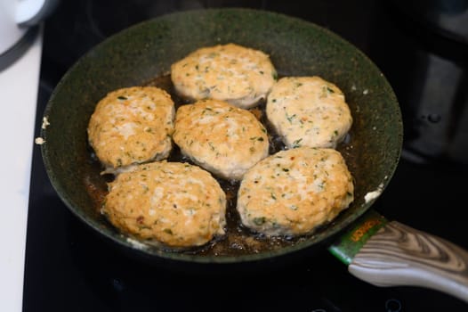 juicy appetizing homemade cutlets frying in a frying pan in the kitchen