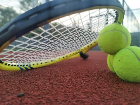 tennis racket with a tennis ball on a tennis court. High quality photo