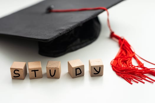 Graduation gap hat and wooden cubes, Education study testing learning teach concept. High quality photo