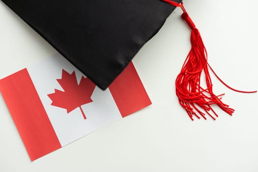 Graduation cap with red tassel isolated on white background. High quality photo