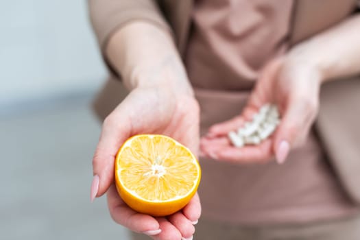 A person holding an orange and medication. High quality photo