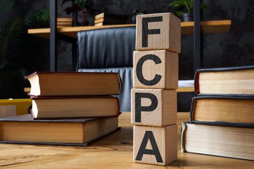 FCPA Foreign Corrupt Practices Act. Cubes with letters on the office table.