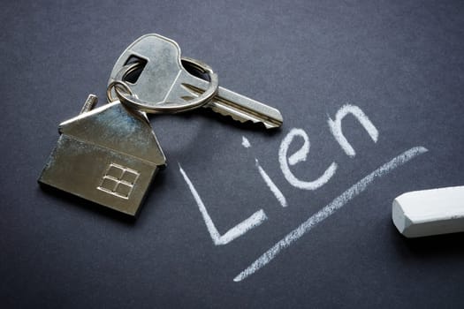 Metal house key and chalk inscription lien.