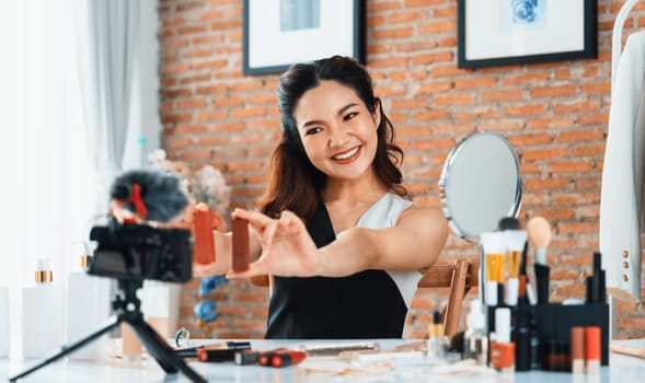 Woman influencer shoot live streaming vlog video review makeup uttermost social media or blog. Happy young girl with cosmetics studio lighting for marketing recording session broadcasting online.