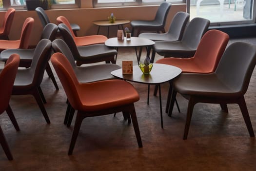 A set of wooden chairs and tables are arranged neatly in a room with hardwood flooring. The furniture adds a cozy touch to the house