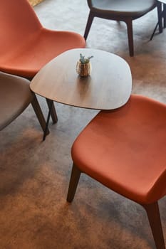 A set of wooden chairs and tables are arranged neatly in a room with hardwood flooring. The furniture adds a cozy touch to the house