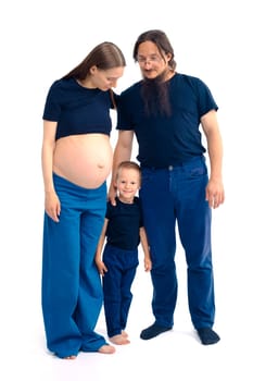 beautiful european happy family with a pregnant mother, the father and a son together. High quality photo