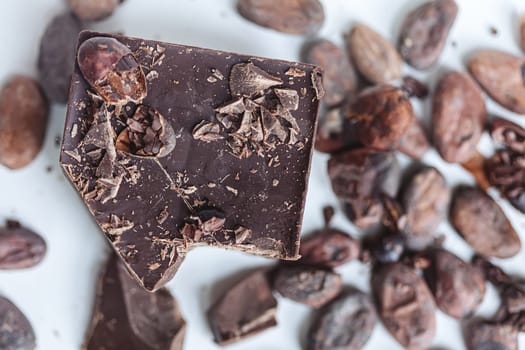 Cocoa beans with chocolate on a white background. Shalllow dof. Top view