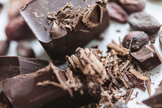 Cocoa beans with chocolate on a white background. Shalllow dof. Top view