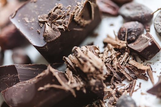 Cocoa beans with chocolate on a white background. Shalllow dof. Top view