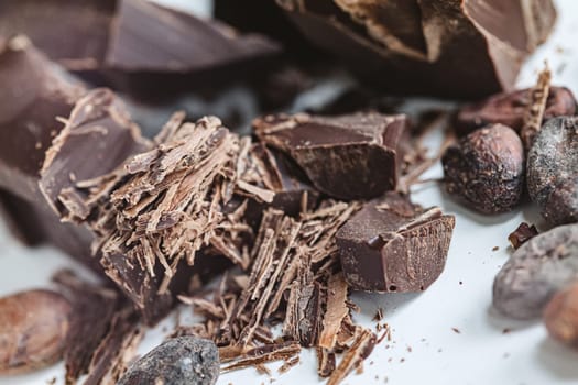 Cocoa beans with chocolate on a white background. Shalllow dof. Top view