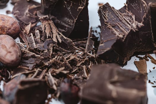 Cocoa beans with chocolate on a white background. Shalllow dof. Top view