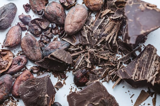 Cocoa beans with chocolate on a white background. Shalllow dof. Top view