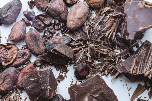 Cocoa beans with chocolate on a white background. Shalllow dof. Top view