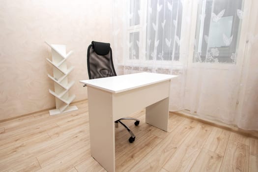 Desk and chair in bright room close up