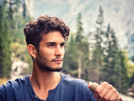 A man sitting in a boat on a lake. Photo of a man peacefully enjoying a boat ride on a serene lake amidst the breathtaking beauty of the Italian Dolomites