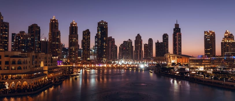 Unique view of Dubai Dancing Fountain show at night. Tourist attraction. Luxury travel destination in charming and beautiful middle east.